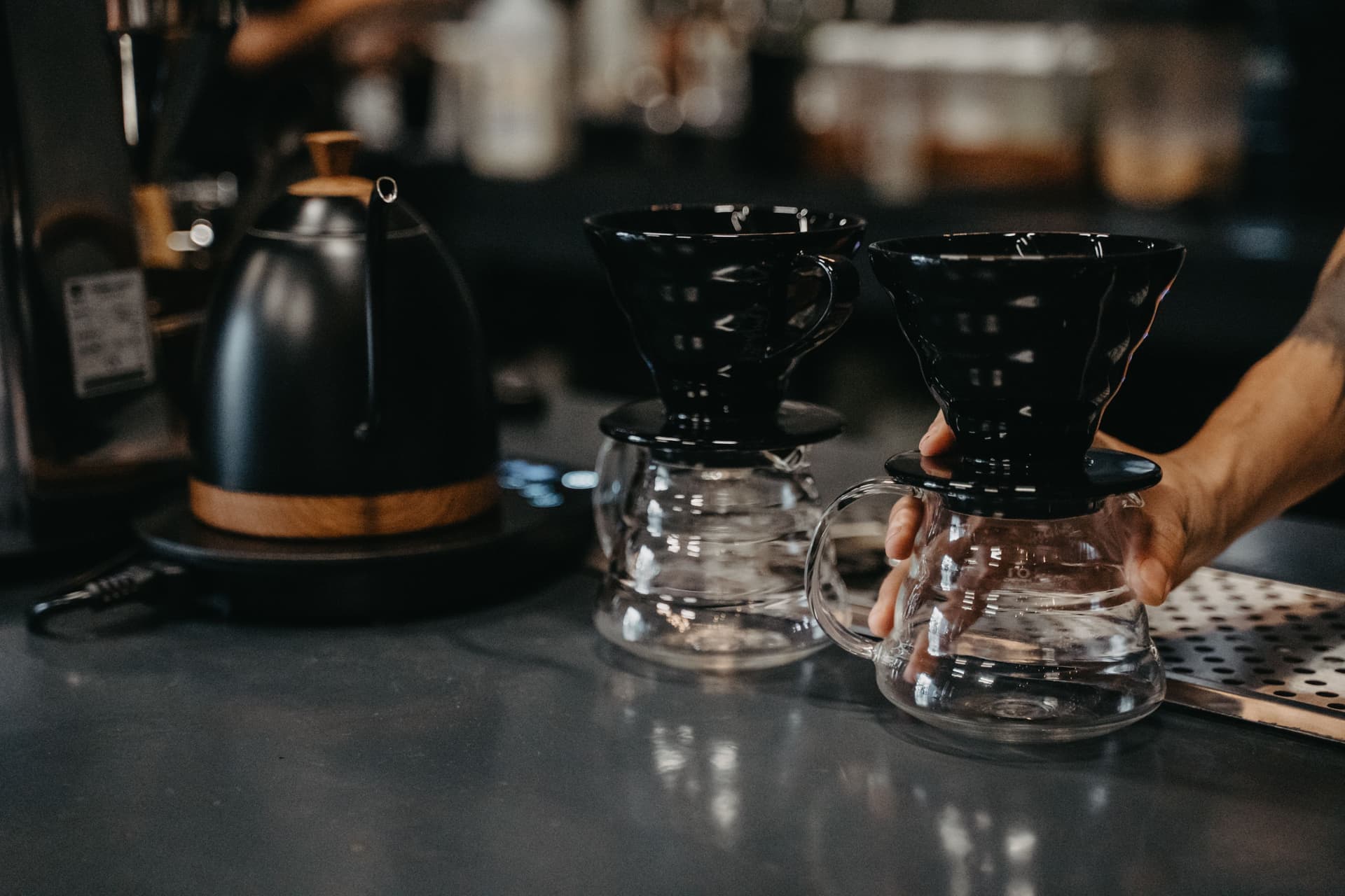 Pour-over coffee dripper and gooseneck kettle on a kitchen counter