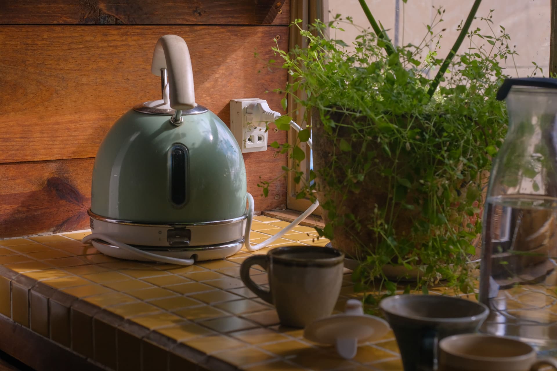 Electric kettle beside a mug on a kitchen counter