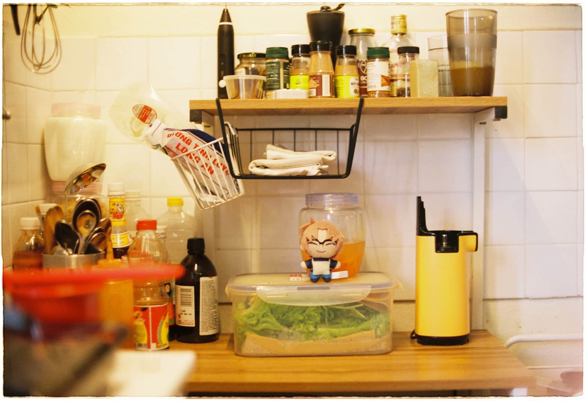 A cluttered kitchen counter crowded with gadgets