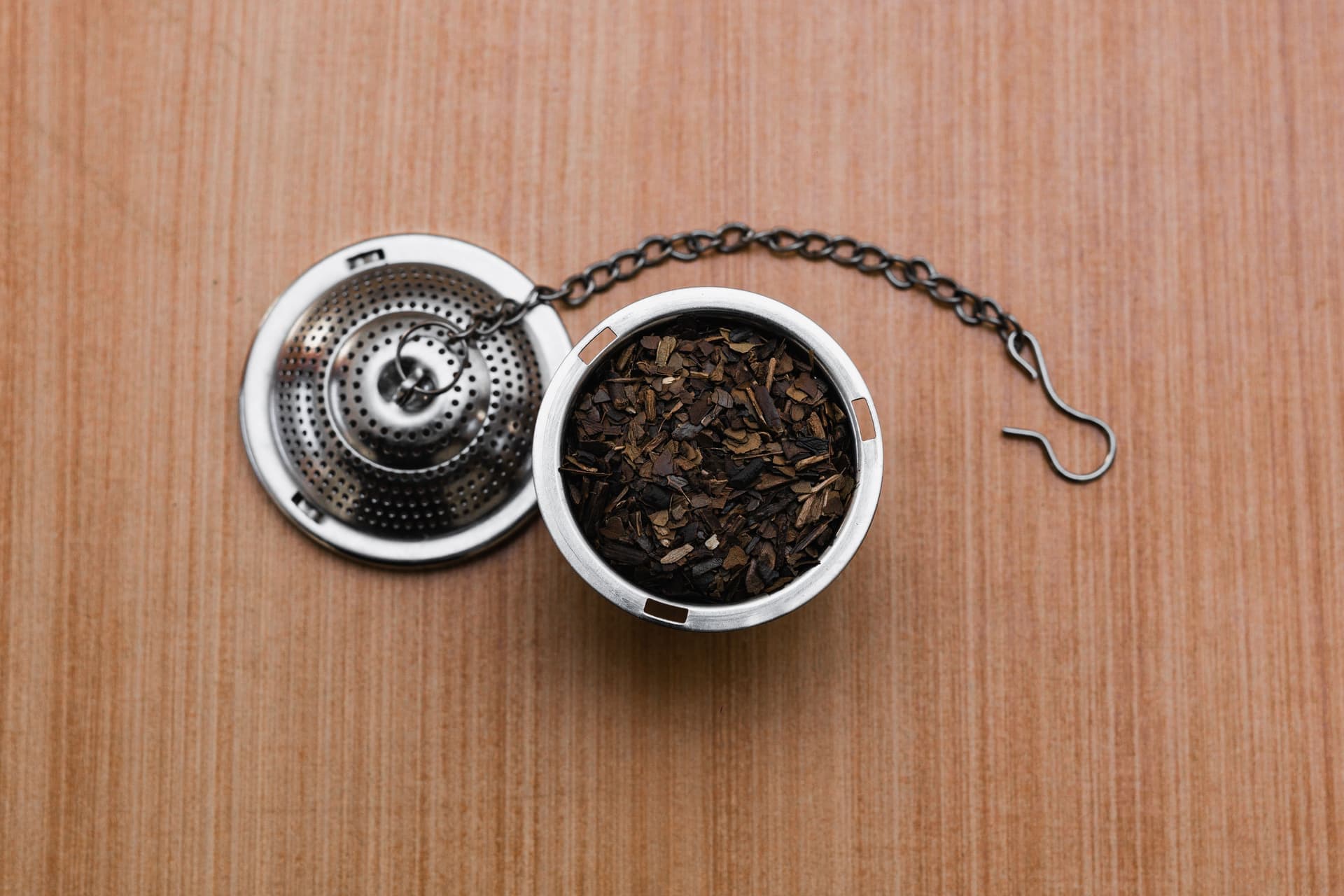 Loose leaf tea sitting in a stainless mesh infuser basket